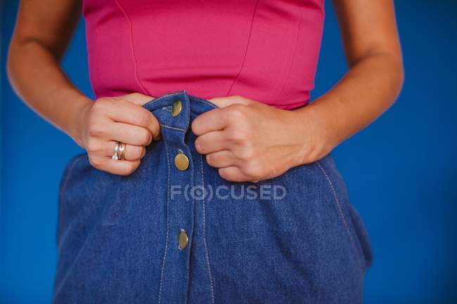 Woman holding up her skirt, cropped image — Stock Photo