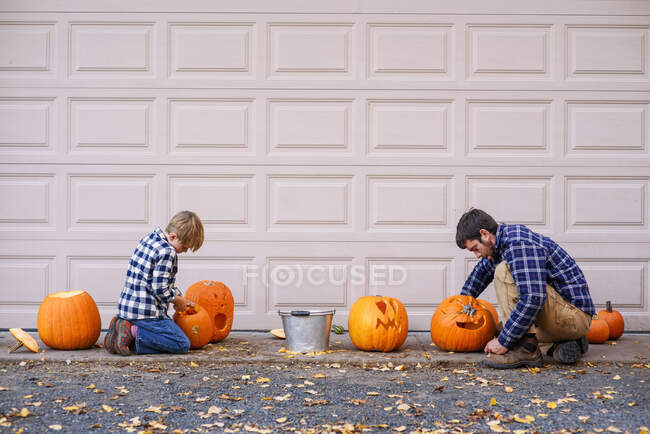 Father and son carving pumpkins — Stock Photo