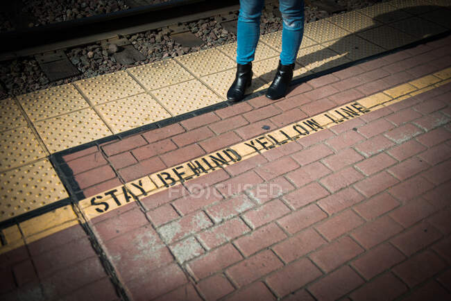 Stay Behind Yellow Line... a rebel crosses the yellow line at this train stop — Stock Photo