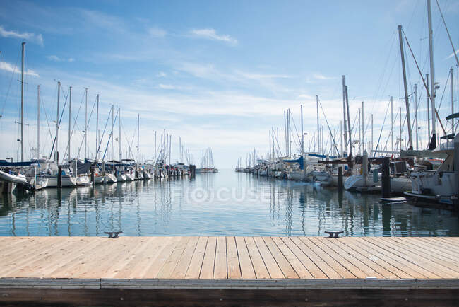 Small harbor with moored yachts in sunlight — Stock Photo