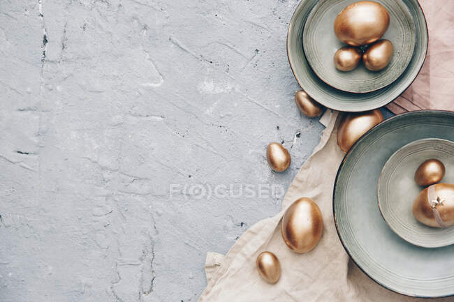 Easter table setting with eggs, top view, flat lay, space for text. — Stock Photo