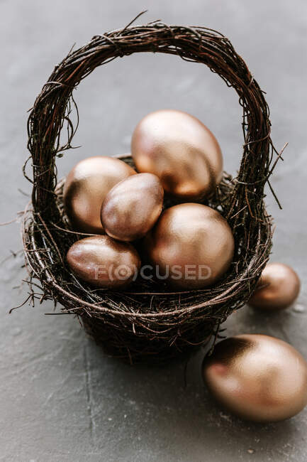 Uova di Pasqua in un nido su superficie di pietra — Foto stock