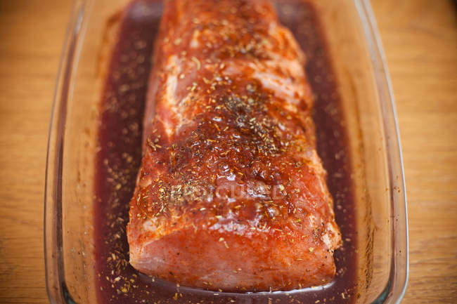 Raw marinated pork tenderloin with herbs — Stock Photo