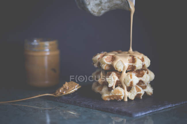 Belgian waffles with hot toffee cream sauce — стокове фото