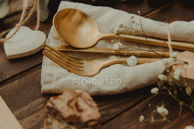 Gold cutlery and heart shape decorations — Stock Photo