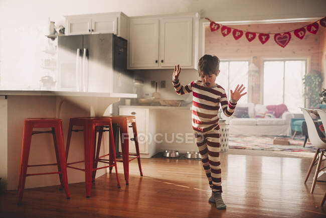 Junge tanzt in der Küche im Schlafanzug — Stockfoto