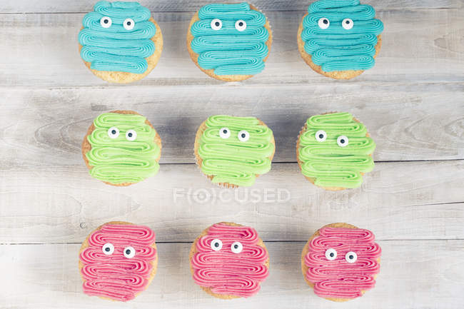 Overhead view of monster cupcakes over table — Stock Photo