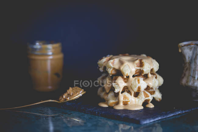 Stack of Belgian waffles with hot toffee cream sauce — Stock Photo