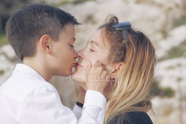 Chico besando a su madre - foto de stock