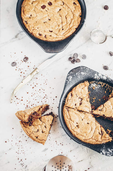 Giant chocolate chip cookies in a baking trays — Stock Photo
