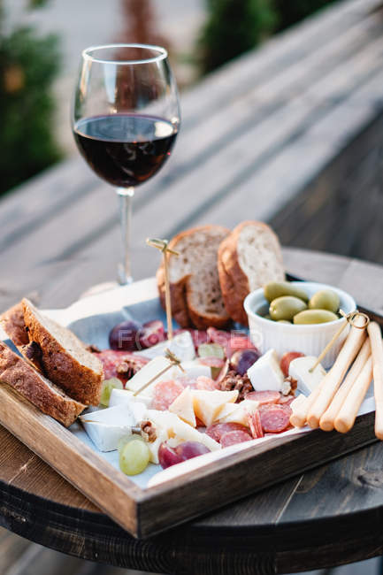 Antipasto and red wine on a table, closeup view — Stock Photo