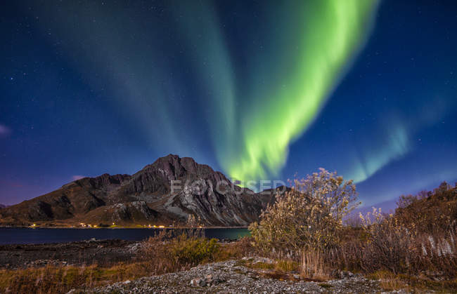 Aurora borealis over Mt. Store Nappstind, Lofoten, Nordland, Norway — стокове фото