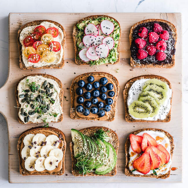 Slices of toast with a variety of healthy toppings — Stock Photo