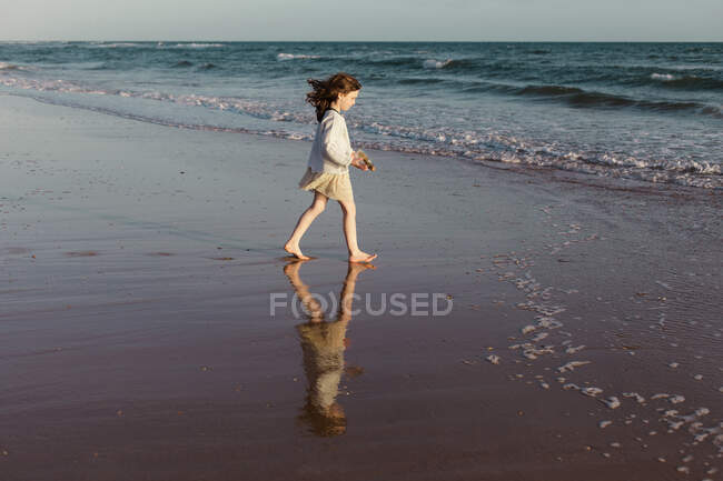 Girl on beach walking towards ocean, Spain — Stock Photo