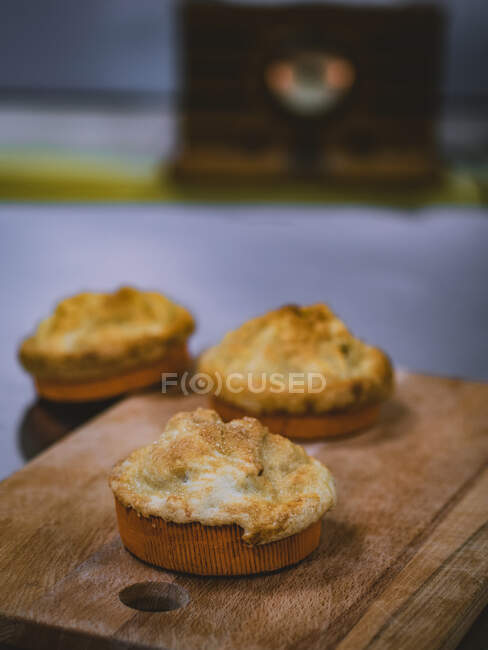 Fresh homemade scones on wooden board — Stock Photo