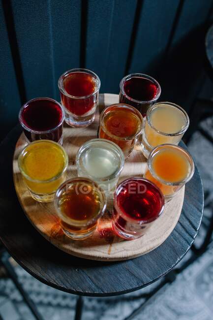 Alcohol shots on a wood stand — Fotografia de Stock