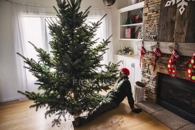 Mann stellt Weihnachtsbaum auf — Stockfoto