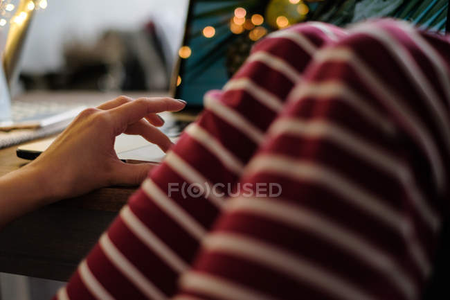 Femme assise à une table en utilisant son ordinateur portable — Photo de stock