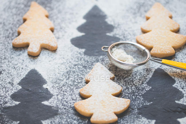 Close-up of Christmas tree cookies with icing sugar — Stock Photo