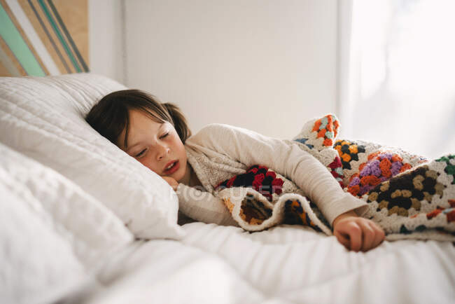 Portrait of a young girl on a bed — Stock Photo