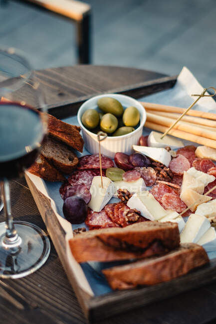 Antipasto and red wine on a table — Stock Photo
