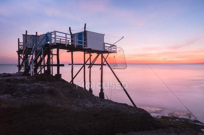 Scenic view of fishing hut at sunset, Charente, Nouvelle-Aquitaine, France — Stock Photo