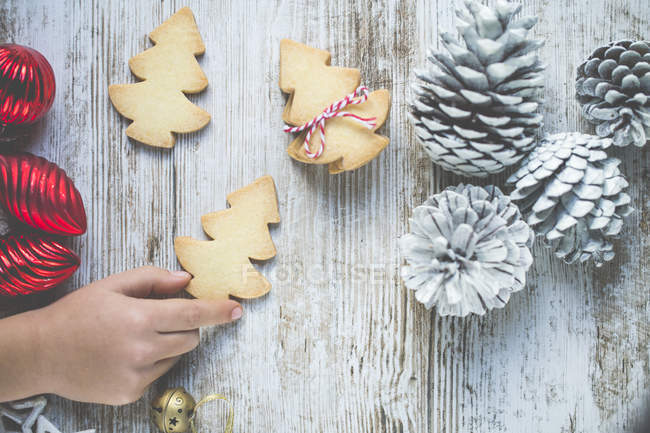 Cropped image of Boy hand reaching for a Christmas cookie — Stock Photo