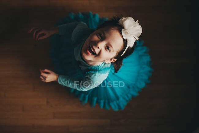 Overhead view of a happy girl spinning around — Stock Photo
