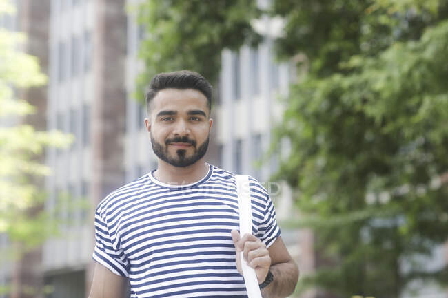 Portrait of a smiling man standing in the city — Stock Photo