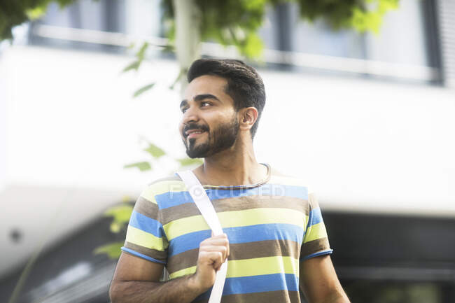 Smiling man standing in the street — Stock Photo