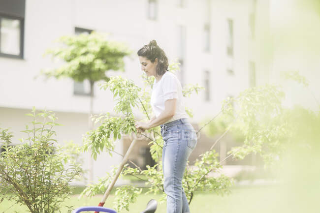 Woman digging in her garden — Stock Photo
