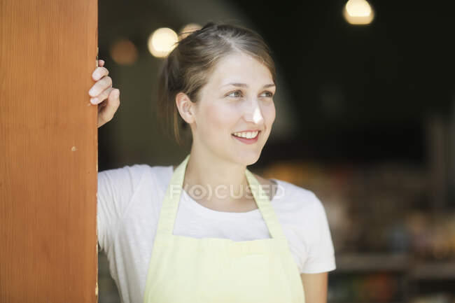 Portrait of a sales assistant standing in a doorway — Stock Photo