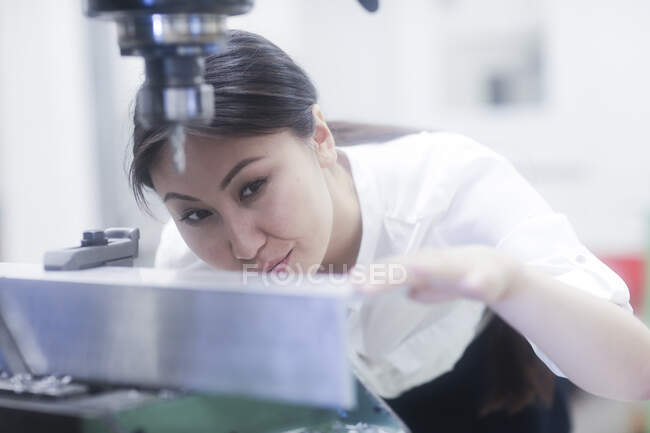 Female engineer preparing to drill a hole in a metal rail — Stock Photo