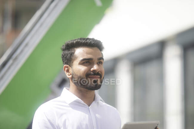 Man standing outdoors using a digital tablet — Stock Photo