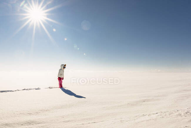 Mädchen steht in einer verschneiten ländlichen Landschaft — Stockfoto