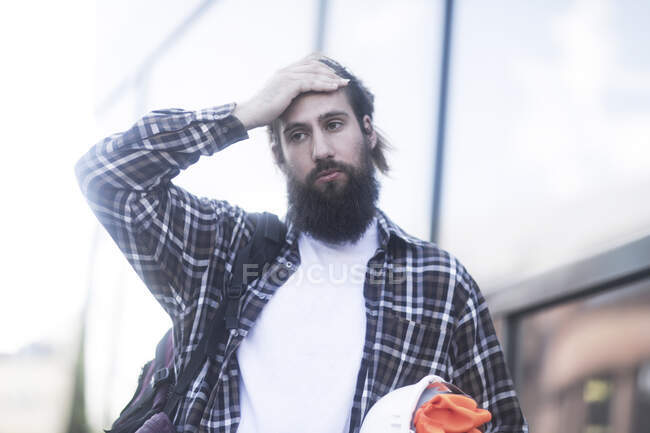 Man standing in the street with his hand on his head — Stock Photo