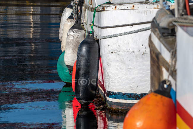 Floats hanging on boats in a harbor — Stock Photo