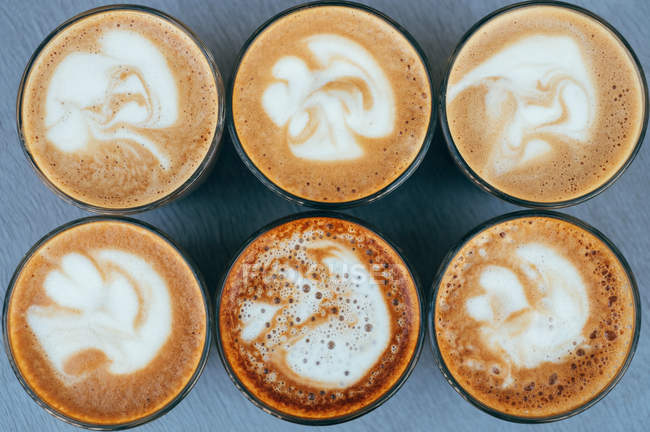 Overhead view of six tasty cappuccinos — Stock Photo