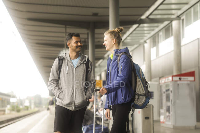 Couple standing on a railway station platform waiting for a train — Stock Photo