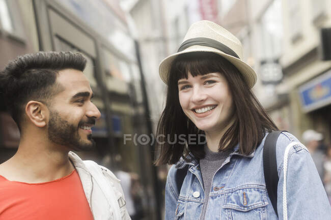 Sonriente pareja de compras en la ciudad - foto de stock