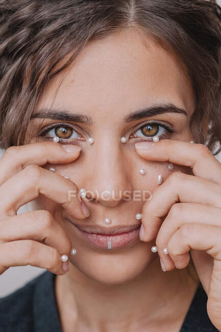 Smiling woman with pearls on her face — Stock Photo