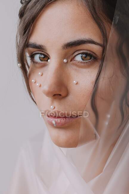 Portrait of a woman with pearls on her face — Stock Photo