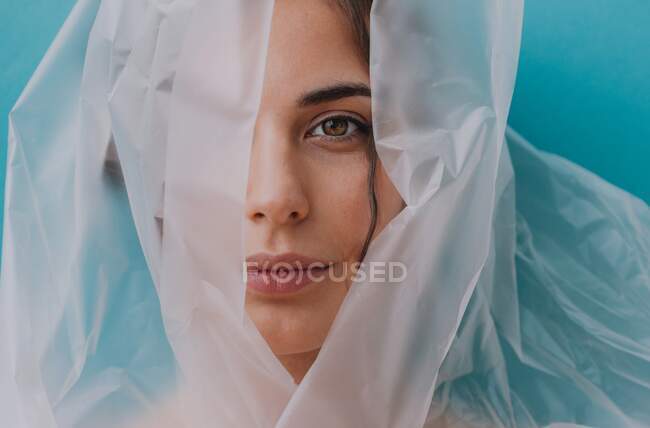 Portrait of a woman wrapped in transparent plastic — Stock Photo