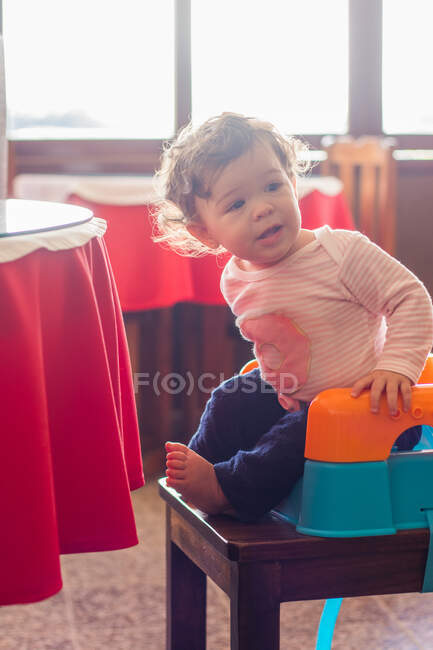 Portrait of a girl sitting in a high chair — Stock Photo