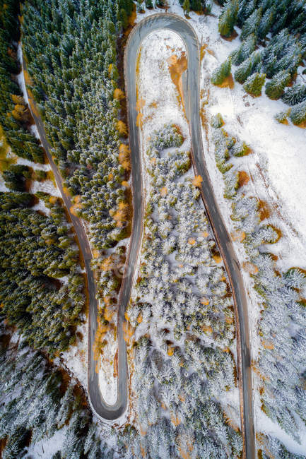 Aerial view of switchback road through a winter forest, Bavaria, Germany — Stock Photo