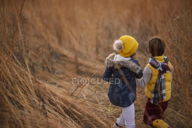 Boy and girl standing in a field, United States — Stock Photo