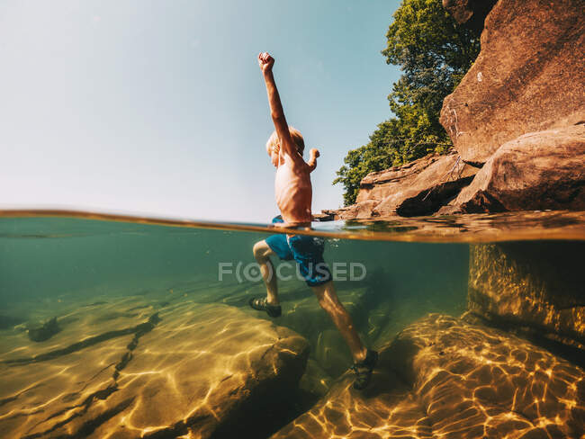 Boy running in a lake, Lake Superior, United States — Stock Photo
