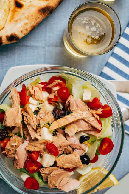 Tuna salad with bread and a glass of beer, top view — Stock Photo