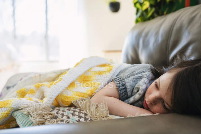 Girl sleeping on a couch — Stock Photo