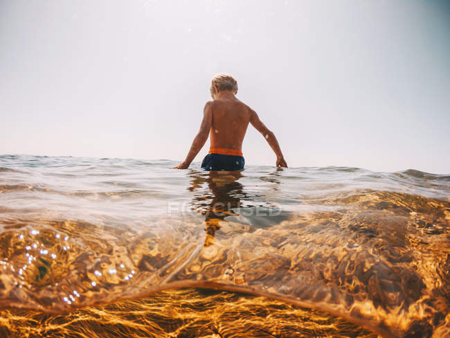 Boy standing in a lake, Lake Superior, United States — Stock Photo